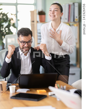 Man and girl office employees is genuinely happy and elated Man and girl office employees is genuinely happy and elated 141926456