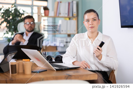 Male and female colleagues are watching presentation in office Male and female colleagues are watching presentation in office 141926594