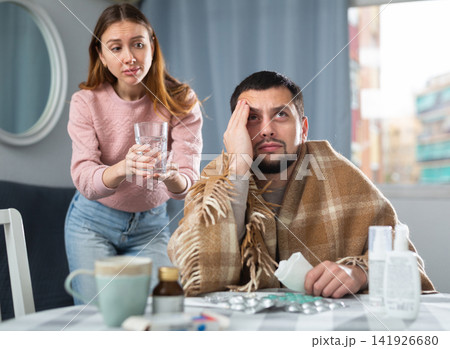 Sick man sitting with wife at home Sick man sitting with wife at home 141926680