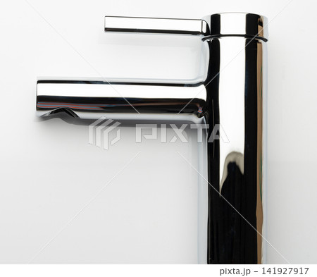 Modern chrome faucet on a white countertop Modern chrome faucet on a white countertop 141927917