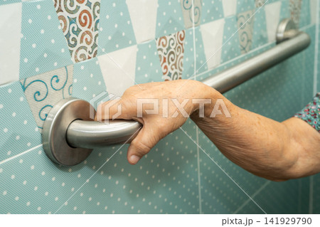 Asian elderly woman patient use toilet bathroom handle security in nursing hospital, healthy strong medical. 141929790