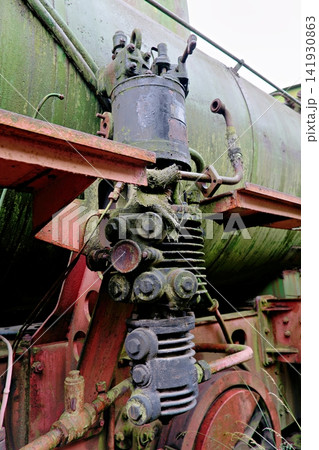 Close up of rusty mechanical valves and pipes on an old steam train Close up of rusty mechanical valves and pipes on an old steam train 141930863