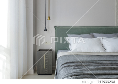 Modern Bedroom Bedside Detail with Nightstand and Pendant Lights 141933238