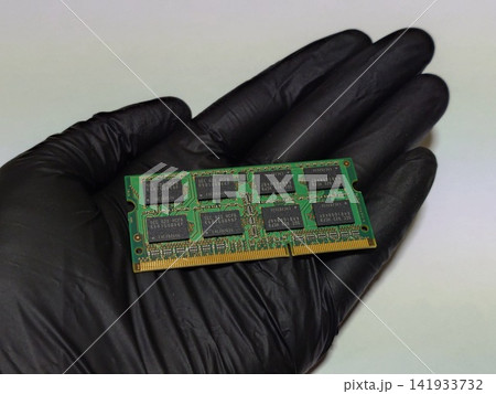 ノートパソコン（PC）のメインメモリ（RAM）1枚を手に持つ 141933732