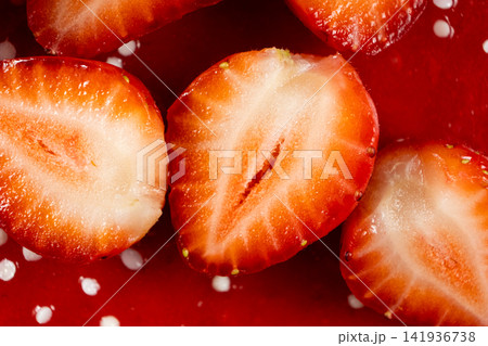 Sliced ripe strawberries on strawberry cake surface Sliced ripe strawberries on strawberry cake surface 141936738