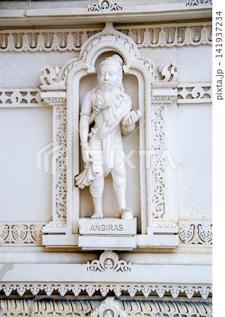 A white marble sculpture of a Hindu saint in the temple. Oldest temple in India. Beautiful sculpture of ancient India 13th century. Wall mounting background. Wall poster.  141937234