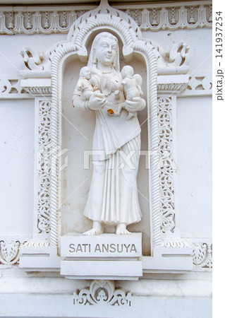A white marble sculpture of a Hindu saint in the temple. Oldest temple in India. Beautiful sculpture of ancient India 13th century. Wall mounting background. Wall poster. A white marble sculpture of a Hindu saint in the temple. Oldest temple in India. Beautiful sculpture of ancient India 13th century. Wall mounting background. Wall poster. 141937254