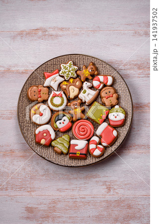 Gingerbread as a Christmas staple, sweet biscuits for the holiday. Gingerbread as a background Gingerbread as a Christmas staple, sweet biscuits for the holiday. Gingerbread as a background 141937502