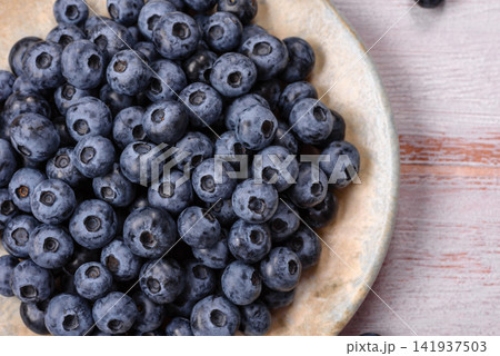 Fresh, ripe, and juicy wild blueberries as an ingredient for vegetarian dishes Fresh, ripe, and juicy wild blueberries as an ingredient for vegetarian dishes 141937503