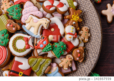 Gingerbread as a Christmas staple, sweets for the holiday interior. Gingerbread as a background Gingerbread as a Christmas staple, sweets for the holiday interior. Gingerbread as a background 141937559