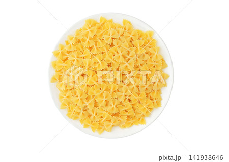 Pasta farfalle on ceramic plate isolated on white background. Top view. Various of uncooked pasta. Delicious with light vegetable, cream or tomato sauces, as well as in cold salads. Pasta farfalle on ceramic plate isolated on white background. Top view. Various of uncooked pasta. Delicious with light vegetable, cream or tomato sauces, as well as in cold salads. 141938646
