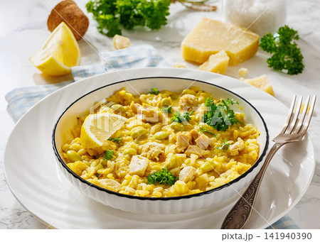 Creamy chicken and yellow rice bowl on a table 141940390