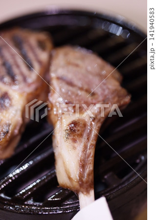 Grilled Lamb Chops on Charcoal Grill 141940583