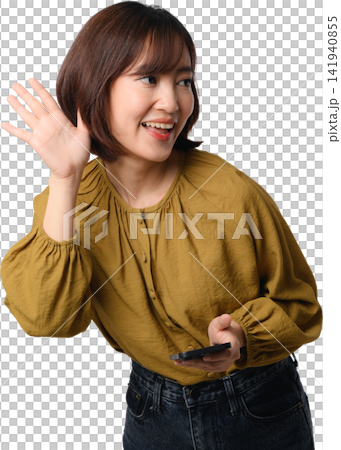 Asian woman waving while holding smartphone with cheerful expression and isolated transparent background 141940855