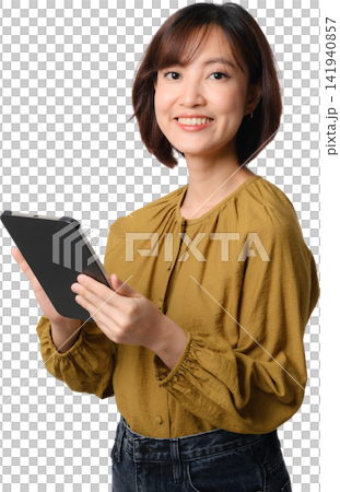 Asian woman holding tablet with friendly smile isolated on transparent background 141940857