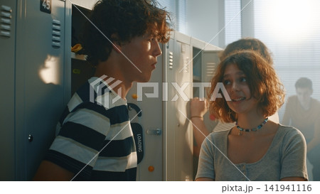 Girls Stealing Notebook and Mocking Boy by School Locker 141941116
