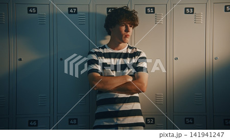 Worried Teenage Student Standing Alone Near School Lockers 141941247