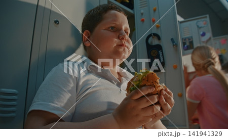 Elementary School Student Taking Time to Enjoy Packed Sandwich before Returning to Class Elementary School Student Taking Time to Enjoy Packed Sandwich before Returning to Class 141941329