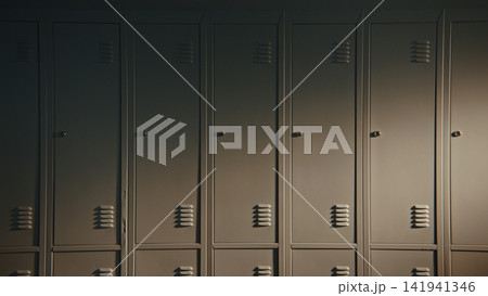 Orderly Rows of Closed Student Lockers Create Minimalist Backdrop in School Corridor 141941346