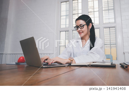 Female doctor working with laptop at office desk in the hospital. Concept of health care and medical. 141941408