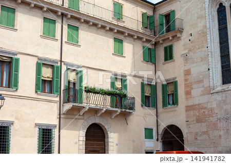 Historic Italian Building Facade with Green Wooden Shutters and Balcony in Verona Italy Historic Italian Building Facade with Green Wooden Shutters and Balcony in Verona Italy 141941782