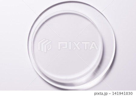 Glass circles on a pink background. A template for placing samples of cosmetics or medical products or food. 141941830