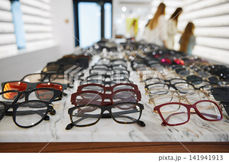 Display of glasses and sunglasses, optical store featuring organized selection of glasses Display of glasses and sunglasses, optical store featuring organized selection of glasses 141941913