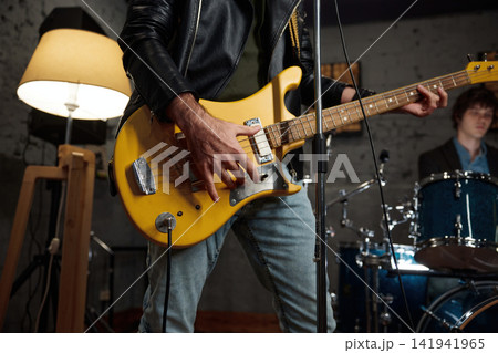 Vivid scene of musician immersed in passionate musical expression in studio Vivid scene of musician immersed in passionate musical expression in studio 141941965