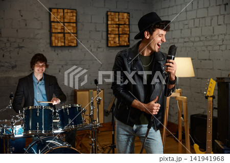 Rock band practicing with intense emotion and vintage style atmosphere Rock band practicing with intense emotion and vintage style atmosphere 141941968