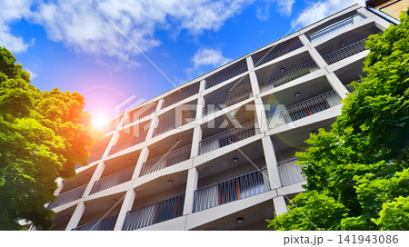 Modern residential building with new apartments in a green residential area. Eco architecture. Green tree and new apartment building. The harmony of nature and modernity. Modern residential building with new apartments in a green residential area. Eco architecture. Green tree and new apartment building. The harmony of nature and modernity. 141943086