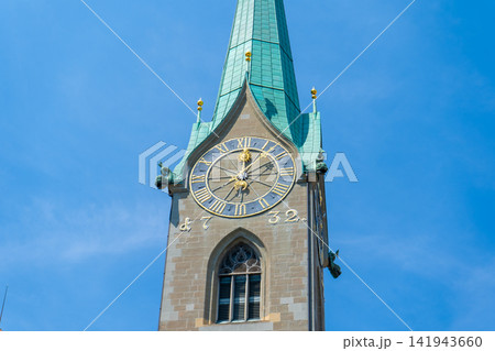 Clock Face on Fraumunster Church Spire with Blue Sky in Zurich City Switzerland 141943660