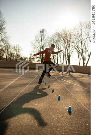 Young man practicing freestyle rollerblading tricks Young man practicing freestyle rollerblading tricks 141943790