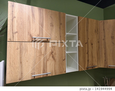 Kitchen sample displayed in a furniture showroom to inspire customers with functional and stylish options Kitchen sample displayed in a furniture showroom to inspire customers with functional and stylish options 141944994