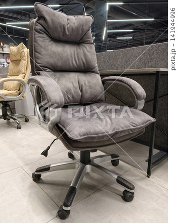 Adjustable grey fabric office chair with height settings for comfort, available in a large shopping mall Adjustable grey fabric office chair with height settings for comfort, available in a large shopping mall 141944996
