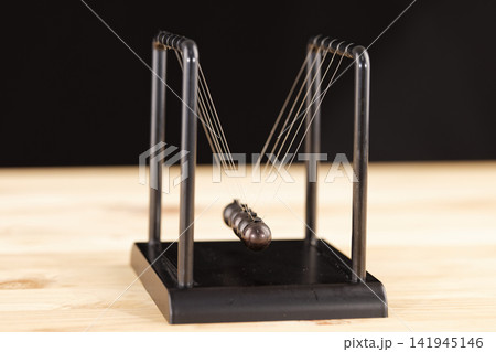 Newton cradle balance balls on the table Newton cradle balance balls on the table 141945146
