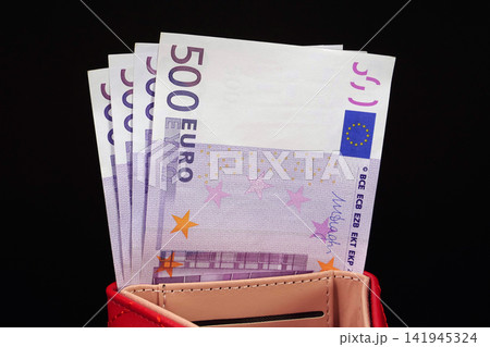 Four 500 Euro bills, neatly arranged in a red wallet, representing 2000 Euros, symbolizing cash flow and financial prosperity Four 500 Euro bills, neatly arranged in a red wallet, representing 2000 Euros, symbolizing cash flow and financial prosperity 141945324