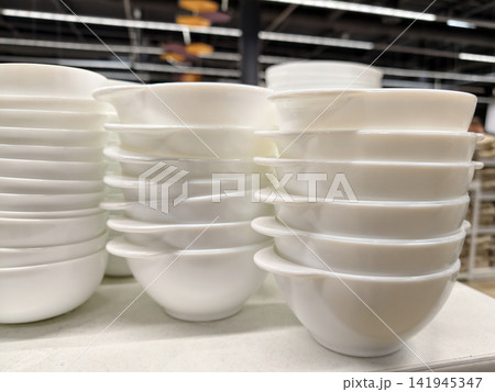 White ceramic tableware including handled bowls arranged on supermarket shelving White ceramic tableware including handled bowls arranged on supermarket shelving 141945347
