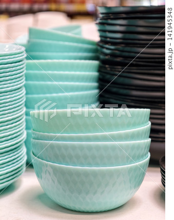 Sky blue salad bowls with textured ribbed surface and uniform round shape arranged in neat stack Sky blue salad bowls with textured ribbed surface and uniform round shape arranged in neat stack 141945348