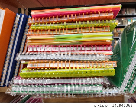 Variety of softcover spiral notebooks on shop shelf Variety of softcover spiral notebooks on shop shelf 141945363