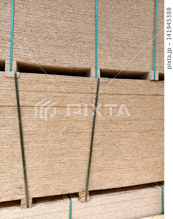 Oriented Strand Board or OSB, large stacks of construction panels and other wood product stored in warehouse Oriented Strand Board or OSB, large stacks of construction panels and other wood product stored in warehouse 141945389