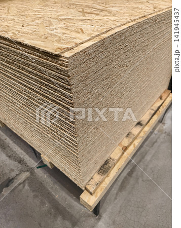 Oriented Strand Board or OSB, structural board from wood strand for renovation and construction stored in retail warehouse Oriented Strand Board or OSB, structural board from wood strand for renovation and construction stored in retail warehouse 141945437