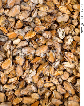 Loose frozen mussels arranged in store freezer for sale Loose frozen mussels arranged in store freezer for sale 141945451
