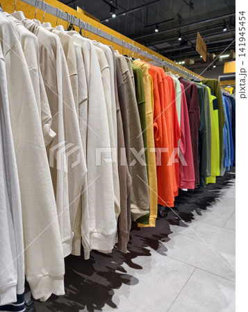 Colorful hoodies inside a sports store present a fresh and diverse assortment of comfortable garments for daily activity and leisure Colorful hoodies inside a sports store present a fresh and diverse assortment of comfortable garments for daily activity and leisure 141945454