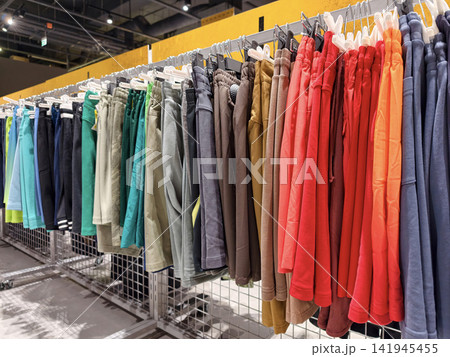 Bright athletic shorts in different colors displayed inside a sports shop highlight a flexible range of apparel designed for comfort and movement Bright athletic shorts in different colors displayed inside a sports shop highlight a flexible range of apparel designed for comfort and movement 141945455