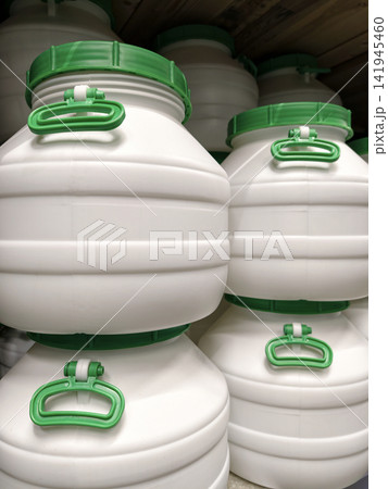 Plastic containers, large and white, displayed on shelves of a hardware superstore Plastic containers, large and white, displayed on shelves of a hardware superstore 141945460