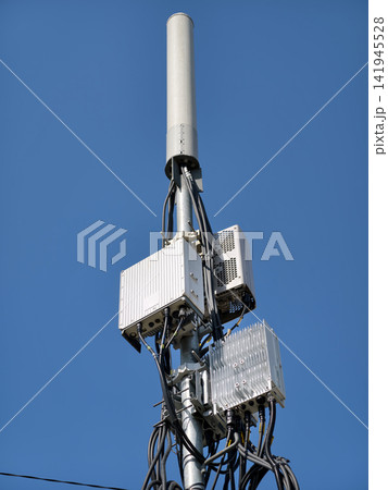 Modern 5G cell tower standing against a clear blue sky 141945528