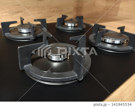 Built in four burner gas stove with metal surface and oven, modern kitchen equipment for cooking, baking and roasting, household appliance for daily meals 141945534
