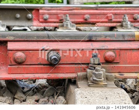 Red track clamp holds rail pad in place for proper signaling and control. Insulating pad is used at joints to electrically isolate rails, which is important for signaling and train control systems Red track clamp holds rail pad in place for proper signaling and control. Insulating pad is used at joints to electrically isolate rails, which is important for signaling and train control systems 141945606