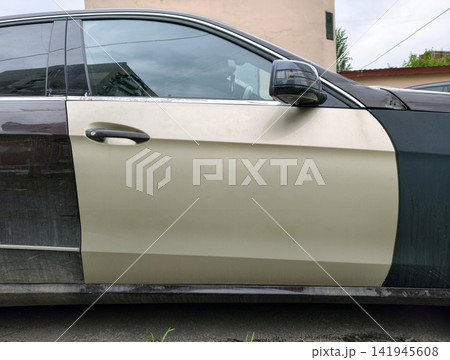 Car with contrasting front door color showing repair work and maintenance Car with contrasting front door color showing repair work and maintenance 141945608