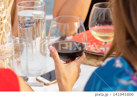 a woman drinking red wine a woman drinking red wine 141945800